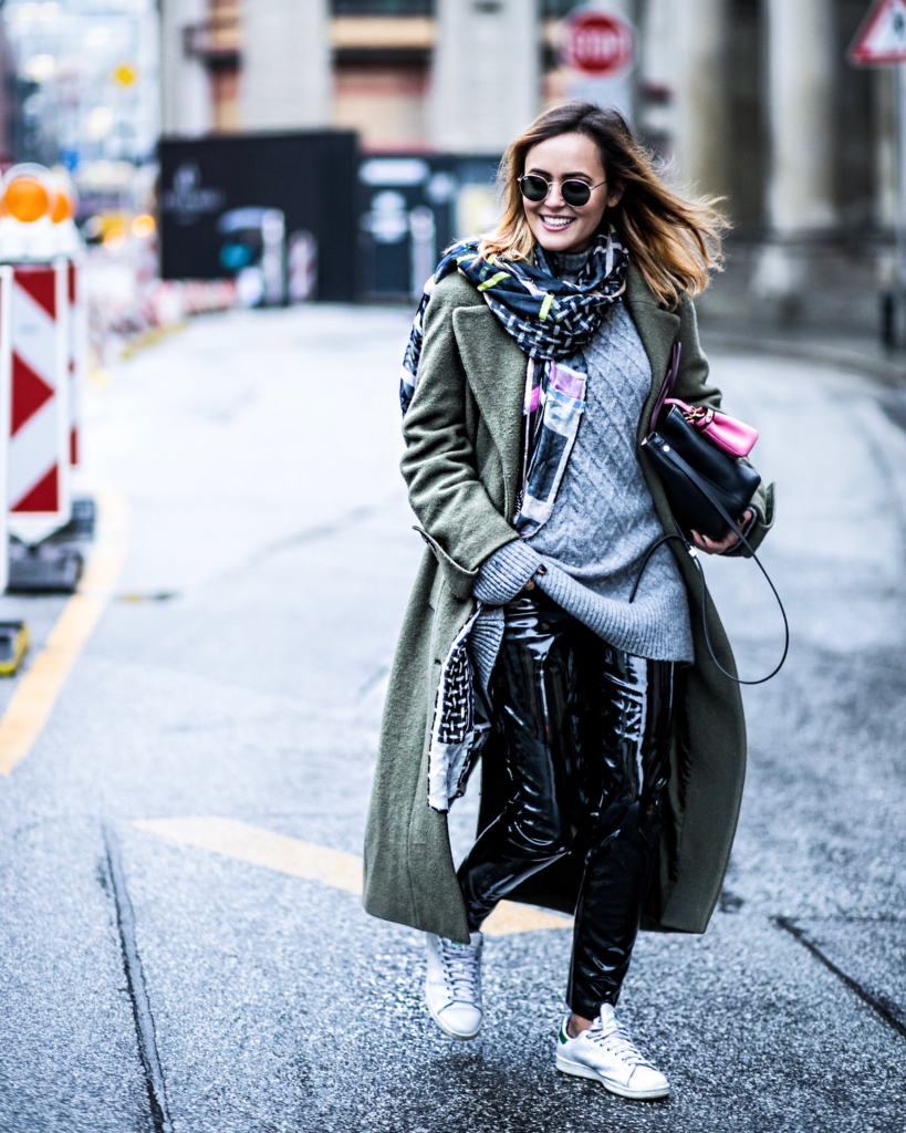 streetstyle - leather pants, knit, olive coat, sunglasses, bag, sneaker, scarf